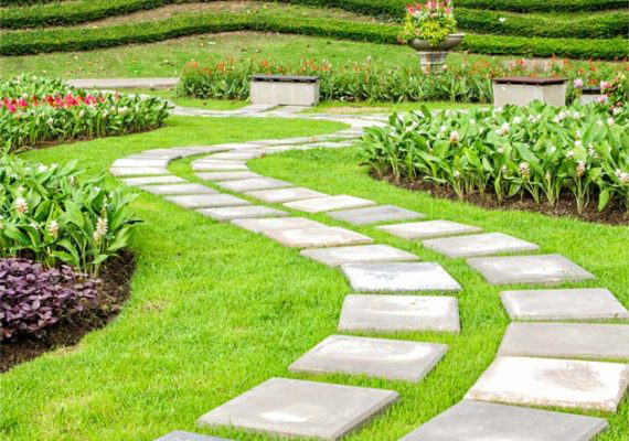 Illustrative example of a formal garden with stone paths, lawn, and layered planting beds.